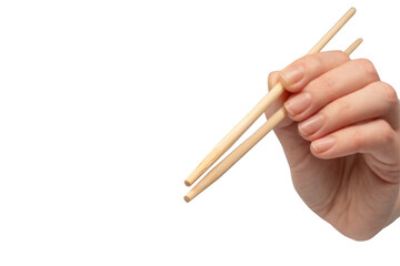 Female hand holding wooden sushi chopsticks isolated on white background.