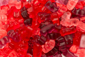 Assorted red gummy candies. Jelly bears.