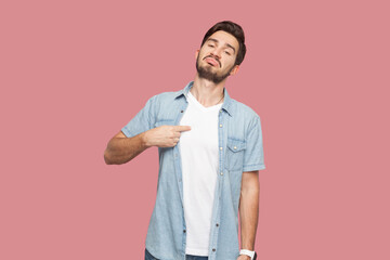 This is me. Satisfied proud bearded man in blue shirt standing points at himself, stands self...