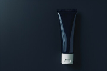 Sleek and simple cosmetic cream tube on a dark navy blue isolated solid background, emphasizing the product's sophisticated design,