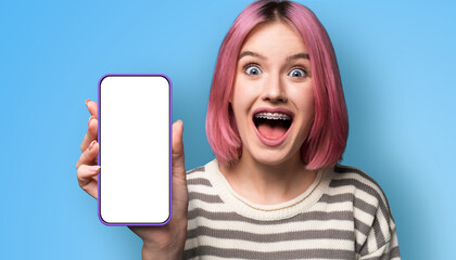 Shock astonished very happy pink woman wear braces, open mouth, show cell phone, modern smartphone...