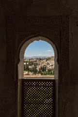 Window view through the city of Granada from Alhambra Palace, Spain.