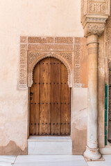 Details of a wooden door and arch in Alhambra Palace, Granada, Spain.