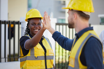 African worker or architect giving hi five pose with coworker at construction site