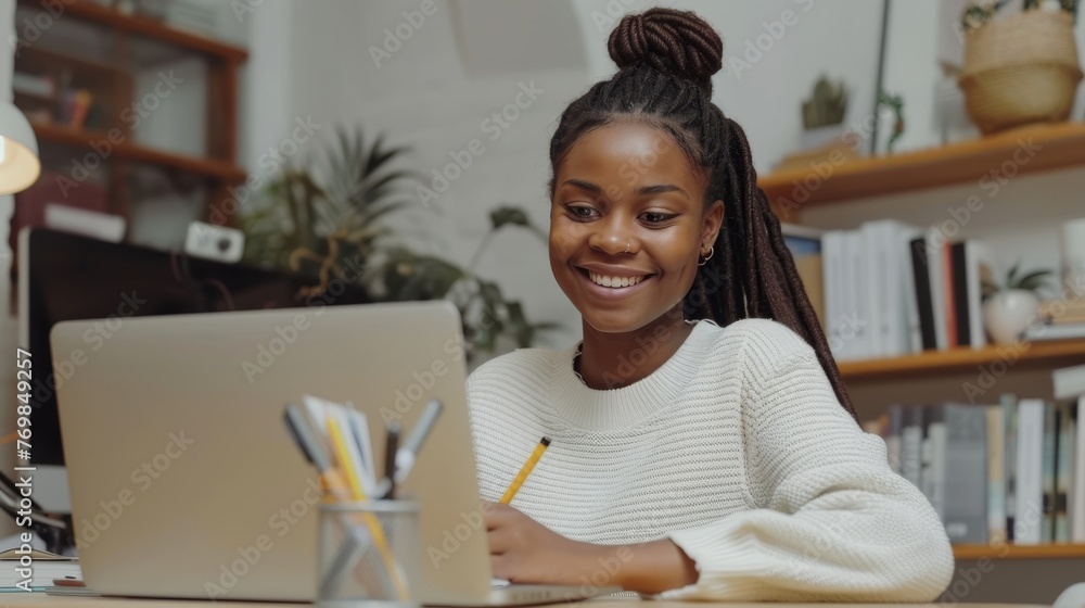 Poster Taking notes, watching tutorials, lectures, or webinars online at home while looking at a screen and using a laptop.