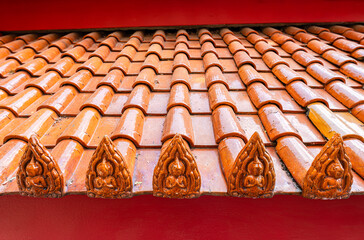 Terracotta tiled roof with carved buddha design