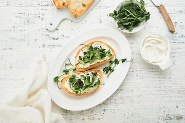 Toast or sandwich with cream cheese and micro greens peas and sunflower. Concept healthy food or snack. Flat lay, copy space.