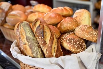 fabric basket full of assorted bread at a bakery counter - 769852839
