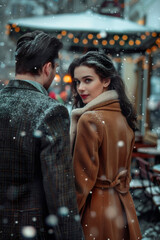 A man and a woman in formal clothes walking down the street in a snowfall