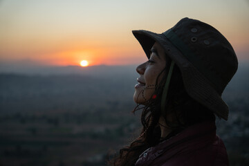 close up mexican young girl in a mountain in the sunset