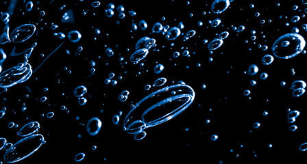 air bubbles in water. dark space background