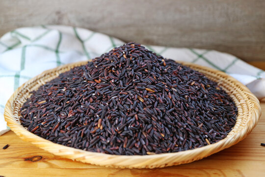 Pile of Uncooked Riceberry Rice, a Healthy Carb of Cross-breed of Jao Hom Nin Rice and Jasmine Rice of Thailand