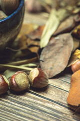 hazelnuts with dead leaves on a table