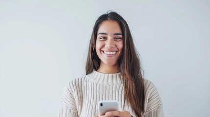 Latin American woman using smartphone, smiling at camera, white background, stock photo