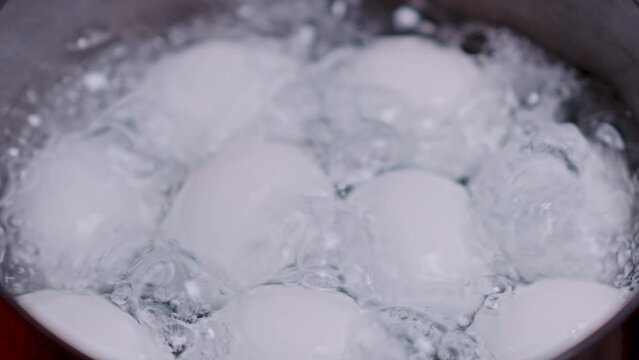chicken eggs are boiled in a ladle with hot water 