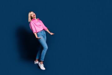 Full size photo of positive girl dressed pink shirt jeans arms hold big invisible box empty space...