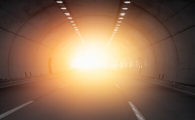 Highway road tunnel with sun light