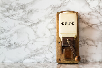 Vintage Wooden Coffee Grinder on White Marble Background with Copy Space