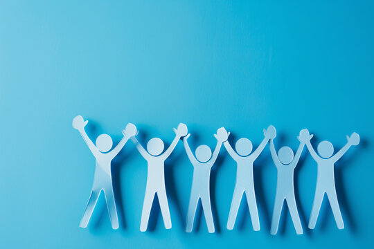 Blue paper people standing and high fiving on blue background with copy space for text, business concept of team work or community group action symbol