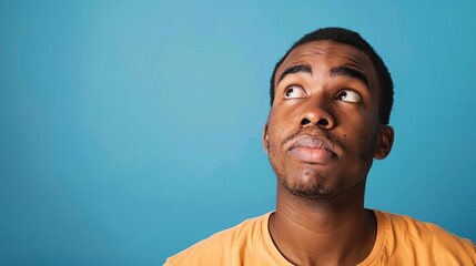 Puzzled African American man with confused expression, blue background portrait photograph - obrazy, fototapety, plakaty