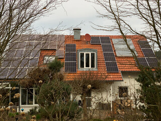 Solar panels on the roof of a house with red tiles