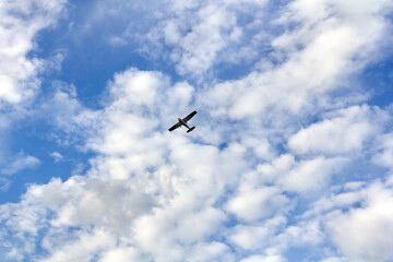 Unmanned drone flying in the sky under the clouds