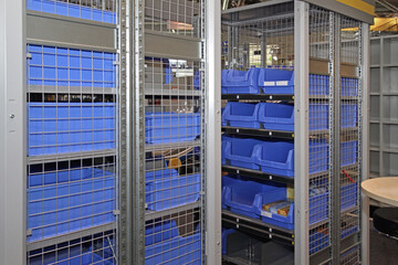Plastic Tray Tote Bins Crates and Boxes at Storage Shelving With Security Wire in Warehouse