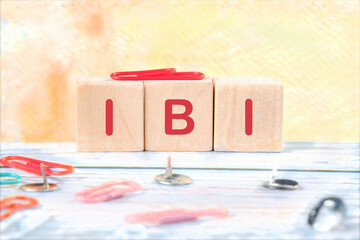 Care concept. IBI wordit is written on wooden cubes on a colored background