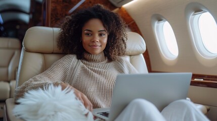A woman is sitting in a plane with a laptop open in front of her