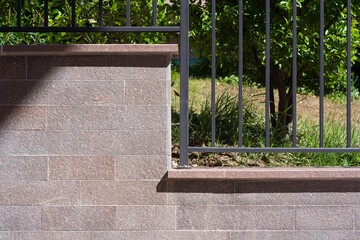 detail of a porphyry border wall and metal railing - obrazy, fototapety, plakaty