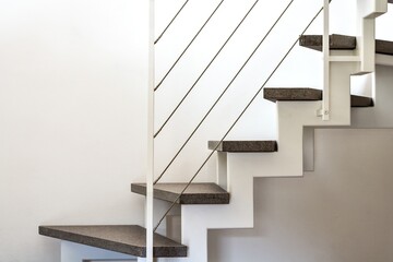 internal home staircase with metal structure, porphyry steps and white metal railing - obrazy, fototapety, plakaty