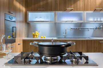 Modern kitchen gas hob with saucepan on shelves background