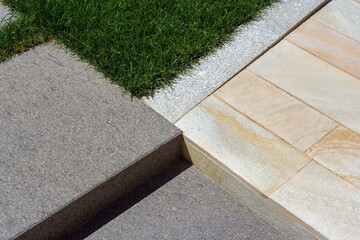 courtyard paving with sandstone plates, porphyry and gray granite curbs - obrazy, fototapety, plakaty
