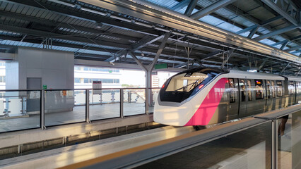 bangkok pink monorail train parked at the station