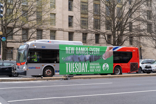 Washington, DC - March 23, 2024: A bus in Washington DC, with a wrap advertisement promoting the lottery scratch off tickets