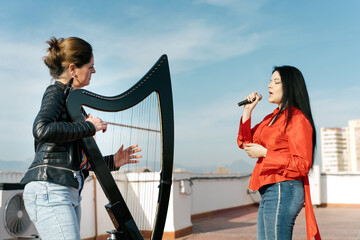 Harp and voice duo performing on the roof of the building
