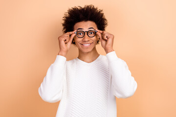 Photo of cheerful funny nice man wear trendy jumper touch glasses isolated on beige color background