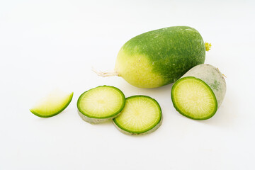 Green radish and radish slices on white background