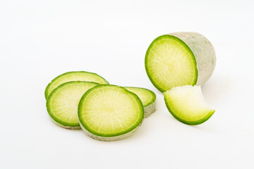 Green radish and radish slices on white background