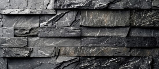 Black modern design decorative cracked stone brick wall pattern. Natural stone texture arrangement.