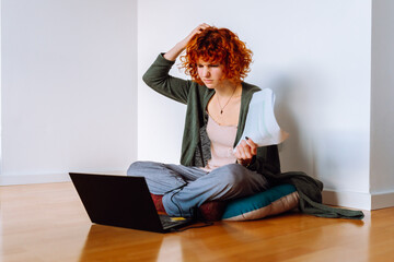 portrait red-haired teenage girl, student, studying online at home