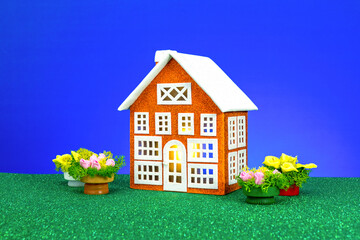 Orange house surrounded by flowers on a blue background