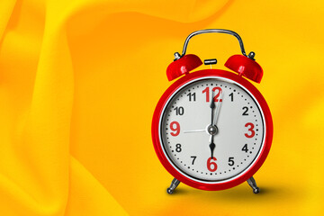 Time alarm clock yellow body  and rings bell  on yellow background.