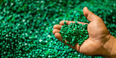 Hand Holding Green Plastic Resin Pellets for Plastic Manufacturing, Overmolding, Low Pressure Overmolding, and Injection Molding Materials