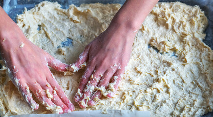 Close up female experienced chef prepares the dough to pizza. Food, the art of cooking and handmade concept. Copy space for text or design.