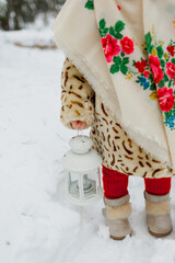 Girl in winter clothes in the forest