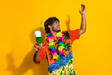 Portrait of positive cool guy wear hawaii shirt hold cocktail look at discount empty space isolated...