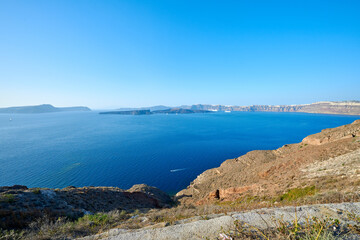 View of the volcanic caldera of Nea Kameni from the southwestern part of the island of Santorini. Travel, relaxation, adventure.