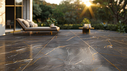 An outdoor patio with dark gray marble tiles, each adorned with unique gold and white veining. 