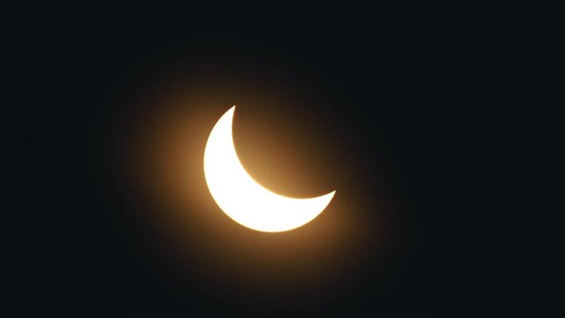 Bright sun around the solar eclipse as bright yellow rays bounce off both sides